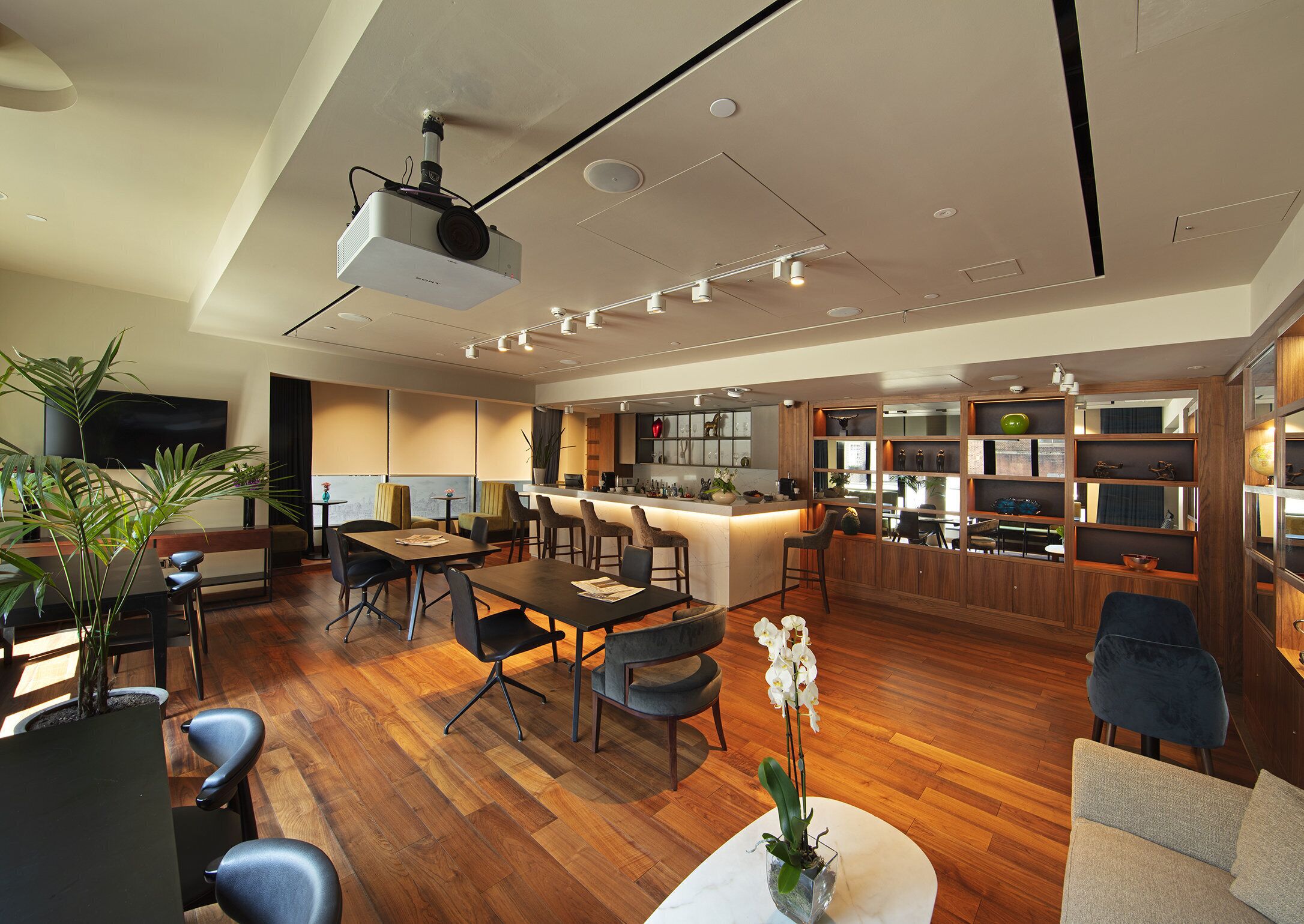 A modern interior with a dining area, kitchen, and bar.