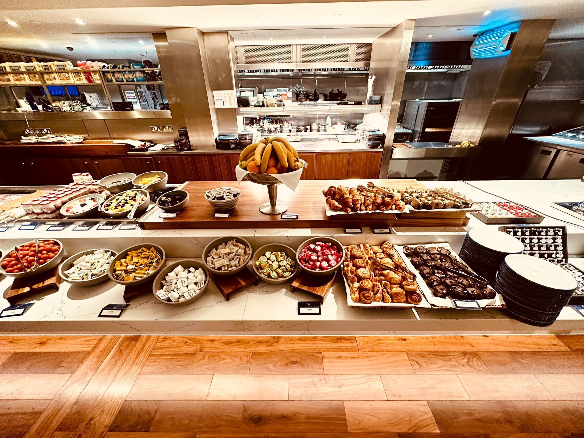A buffet with various food items and a central fruit bowl.