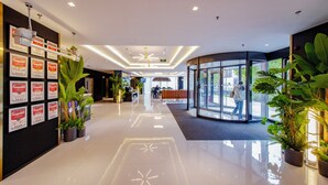 A modern hotel lobby with a clean, polished floor, a reception area, and a glass entrance. - Holiday Inn Express Beijing Shijingshan Lakeview by IHG (Beijing)