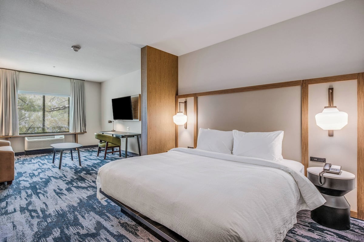 Premium bedding, desk, laptop workspace, blackout drapes