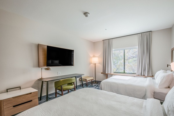 Premium bedding, desk, laptop workspace, blackout drapes