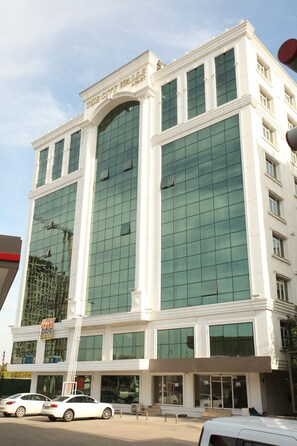 A multi-story building with large glass windows and a white facade. - The City Walls Suit Hotel (Diyarbakir)