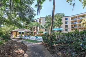 A resort with a pool area, lounge chairs, and a covered seating area. - Hip Nautic - Couple's Getaway, Indoor Pool Hot Tub, Walk to Beach, Pickleball (Hilton Head Island)