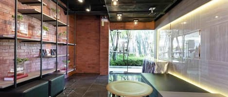 A modern interior with brick walls, wooden shelves, and seating areas.
