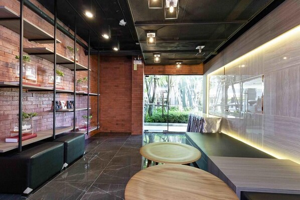 A modern interior with brick walls, wooden shelves, and seating areas.