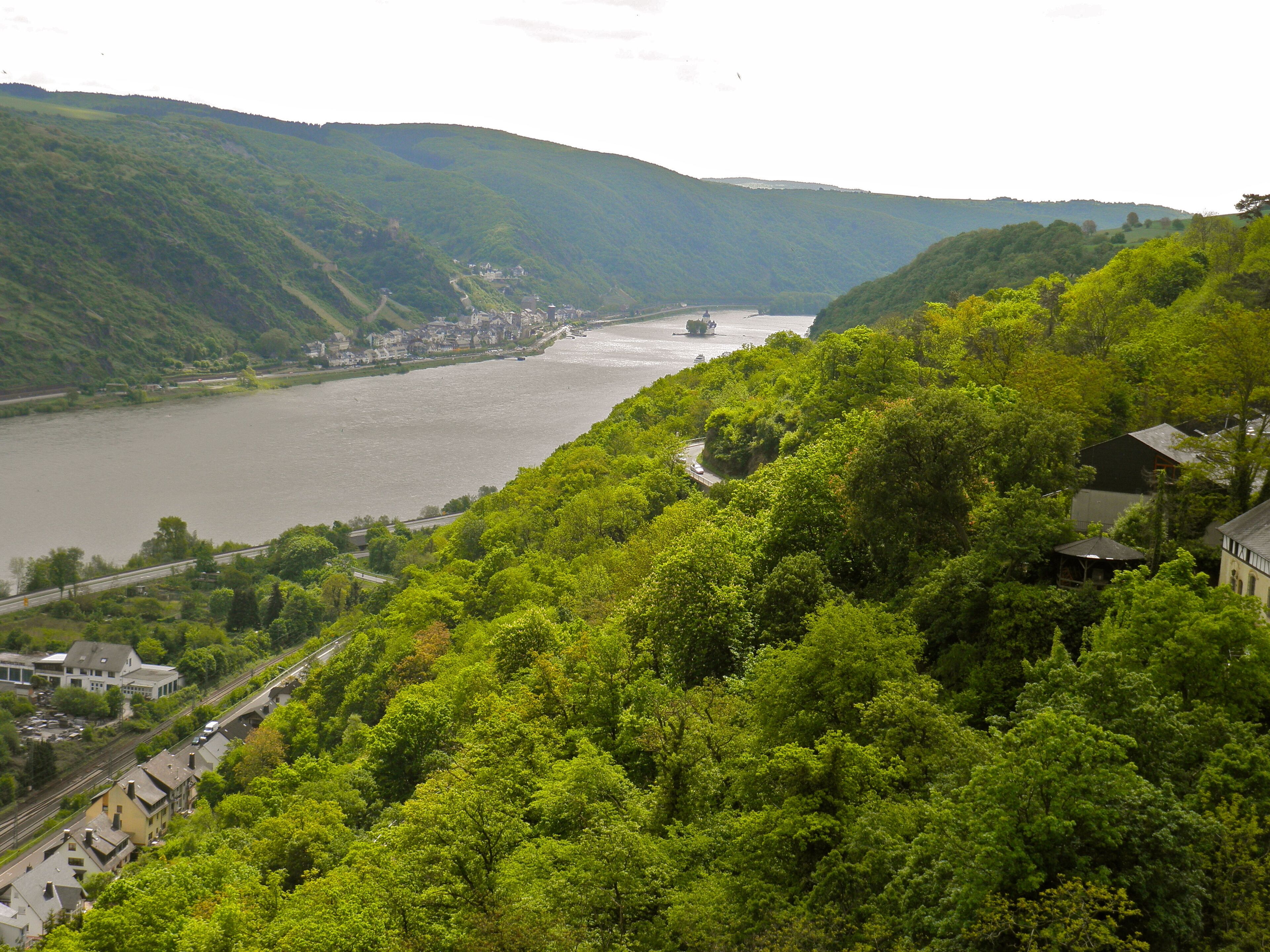 A river valley with lush greenery and a small town.