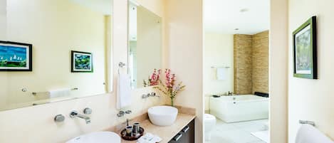 A modern bathroom with two sinks, a large mirror, and a bathtub.