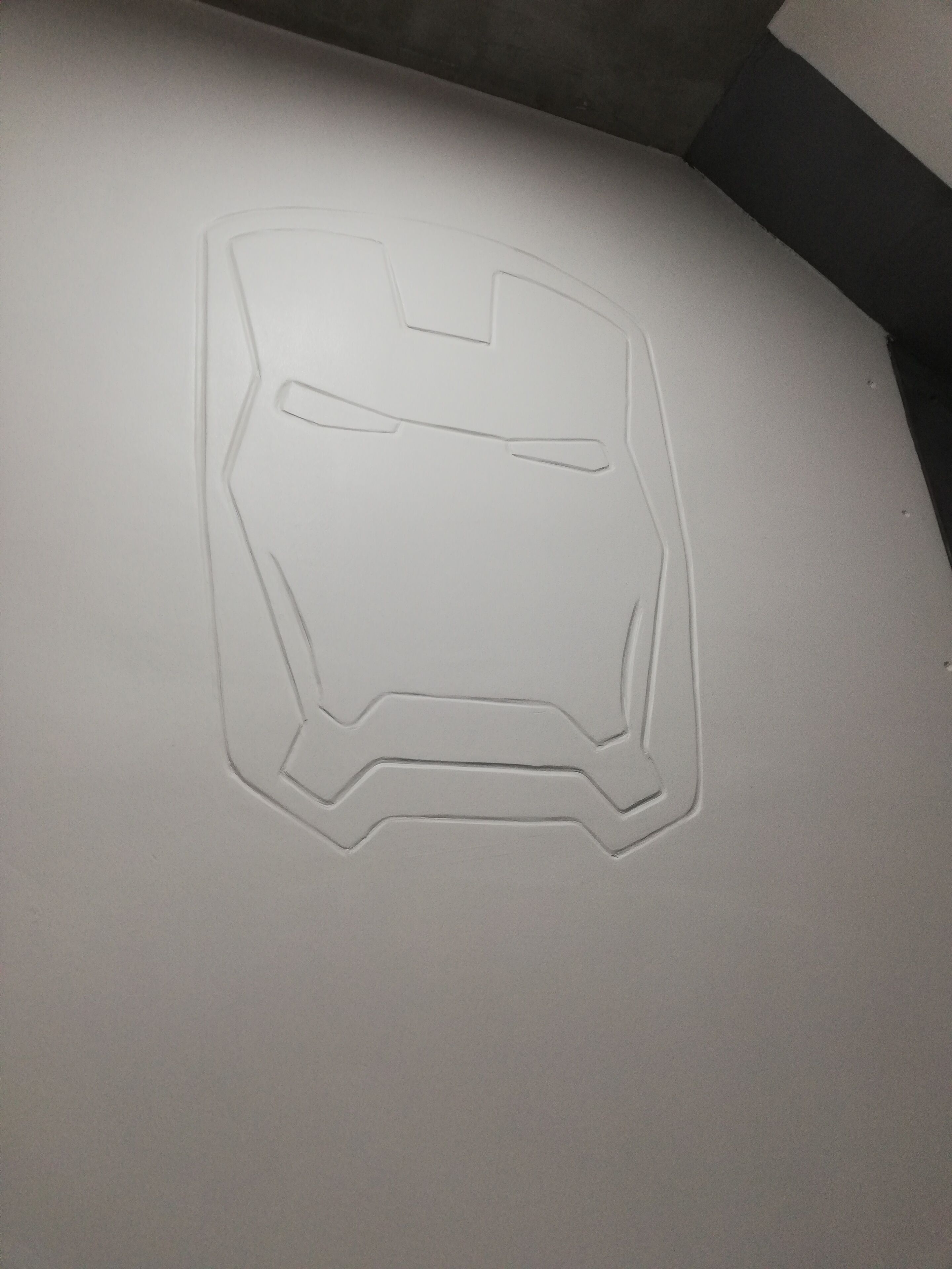 A white embossed logo on a surface.