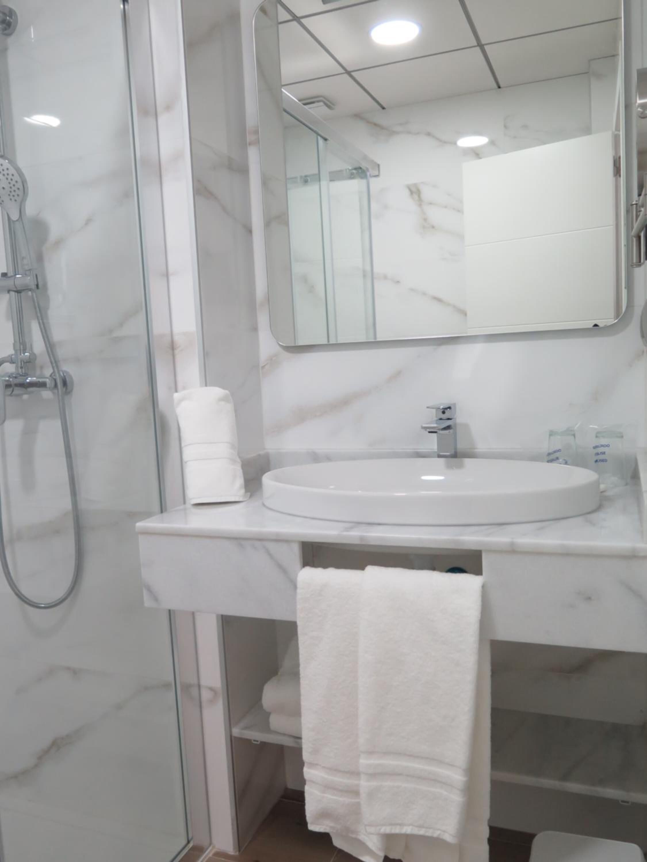 rainfall showerhead, hair dryer, towels, soap