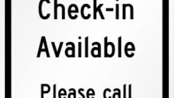 A sign indicating a contactless check-in is available and provides a phone number for assistance.