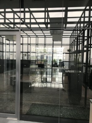 Interior space with a modern design, featuring a grid-like partition and polished floor.