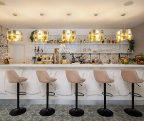 A bar area with multiple stools, a bar counter, and overhead lighting. - Bellevue Maradiso Village by Aminess (Orebic)