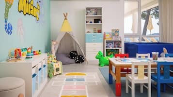 A child's playroom with a tent, toys, and a bookshelf.