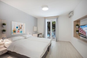 A modern bedroom with a bed, bedside table, and a painting. - Bellevue Maradiso Village by Aminess (Orebic)