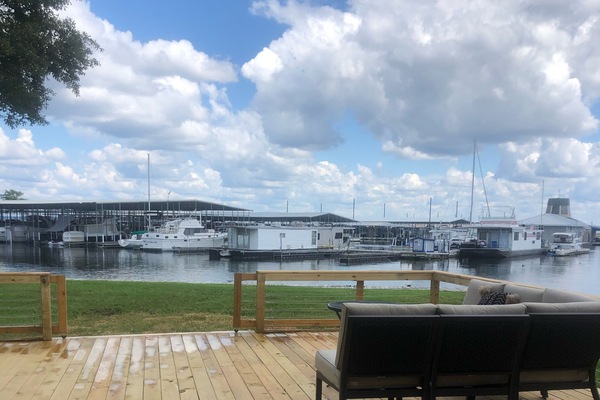 Fully enclosed wood deck with lounge seating and Weber grill.