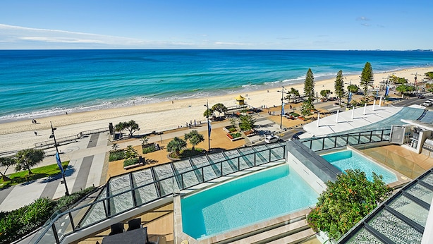 A resort with a pool, beach view, and a promenade. - Soul Private Apartments (Surfers Paradise)