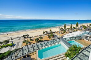 A resort with a pool, beach view, and a promenade. - Soul Private Apartments (Surfers Paradise)