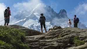 A group of people standing on a rocky mountain peak with snow-covered mountains in the background. - Apt Lachenal209A Central Chamonix Lift 3-min Walk, Chamonix, France (Chamonix)