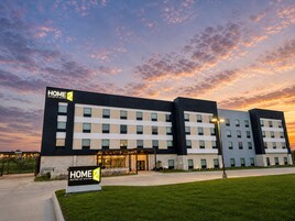 A modern hotel with a flat facade, multiple windows, and a sign indicating it is a Hilton property.