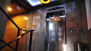 An elevator with a digital display, a glass door, and a metal staircase. - 7 Motel (Gimhae)