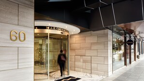 A modern building entrance with a glass door, a marble floor, and a sign indicating the address as 60. - Crowne Plaza Sydney Burwood by IHG (Burwood)