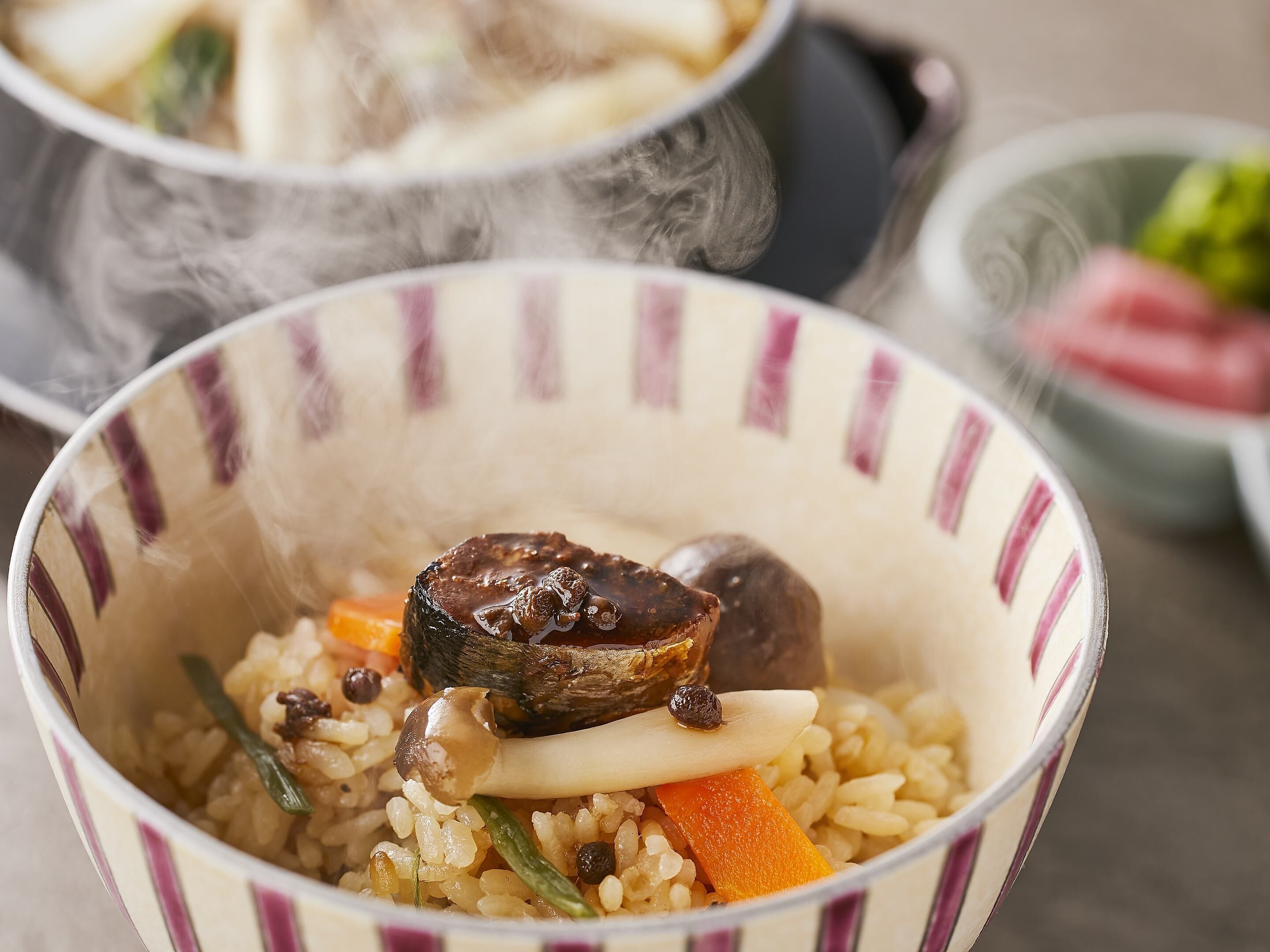A bowl of rice with vegetables and mushrooms.