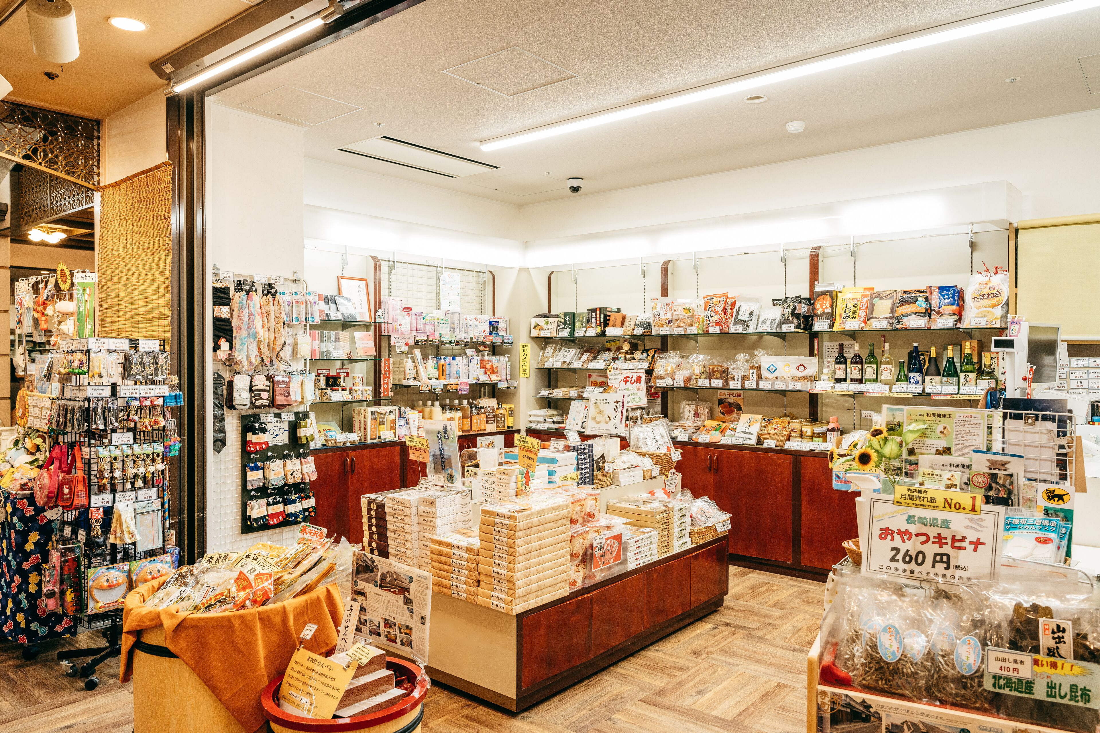 A well-lit store with various products on shelves and counters, including snacks and packaged goods.