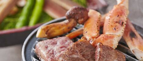 A grill with various meats and vegetables.