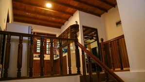 A wooden staircase with a handrail, leading to a second-floor landing. - Southern Coastal Villas (Hikkaduwa)