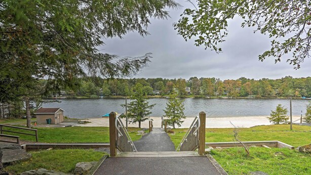 A pathway leading to a beach with a view of a lake and trees. - 15 Mi to Camelback Ski Resort: Home w/ Deck! (Tobyhanna)