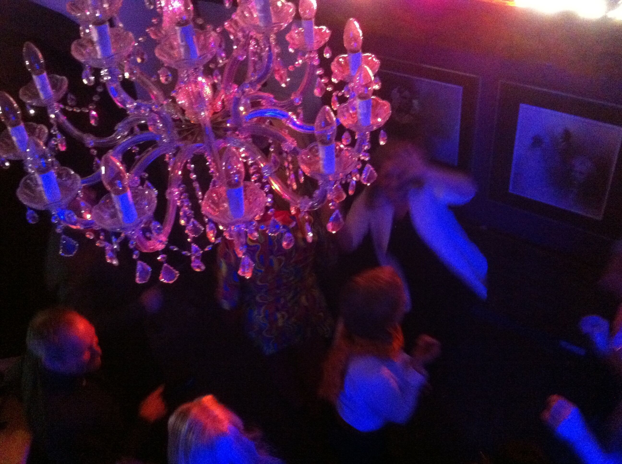A chandelier with multiple tiers and crystal decorations.