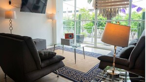 Un salon moderne avec un canapé, une table basse et un téléviseur fixé au mur.