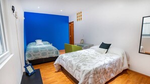 A bedroom with two beds, a desk, and a chair. - Comfortable apartment in Masaryk Avenue 1A (Polanco)
