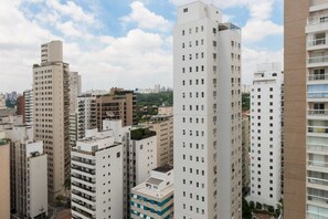 Un immeuble résidentiel de grande hauteur, doté de nombreux étages, de balcons et d’un toit plat.
