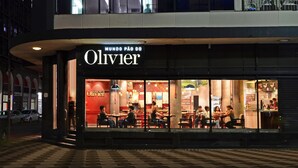 A restaurant named Olivier with outdoor seating and a checkered floor pattern.