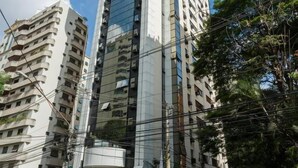 A modern high-rise building with a cylindrical top, surrounded by other residential buildings. - Ce806 Flat Para 1 ou 2 Pessoas nos Jardins! (São Paulo)