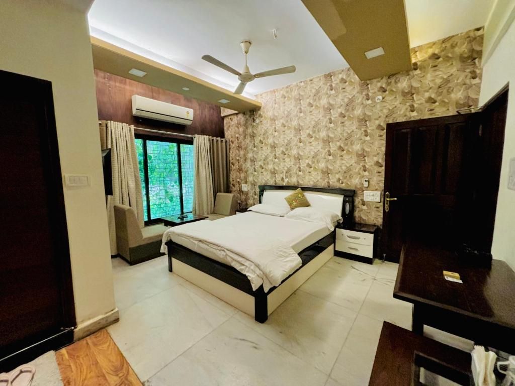 A bedroom with a bed, a nightstand, a wardrobe, and a ceiling fan.
