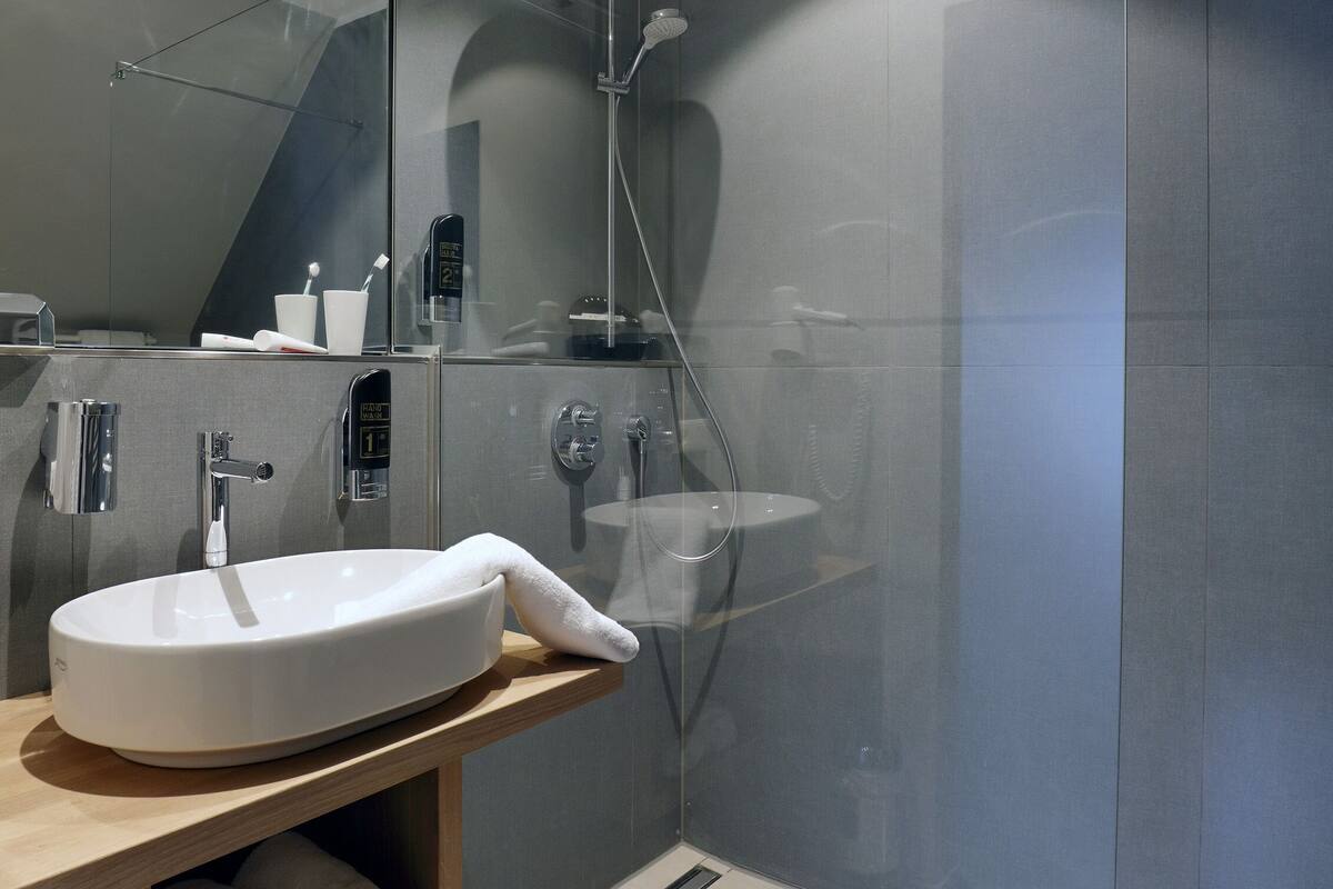 design double room | bathroom | hair dryer, slippers, towels, soap