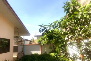 residence with a garden, featuring a window and door.