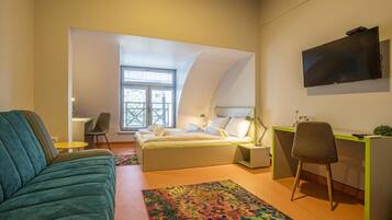 Deluxe Studio | Living area | Flat-screen TV