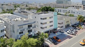 A modern building with a sign labeled "NOSTEL" and a rooftop with solar panels.
