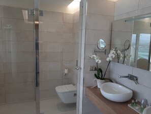 Suite Premium, bañera de hidromasaje, vistas al mar | Baño | Ducha, artículos de higiene personal gratuitos y secador de pelo