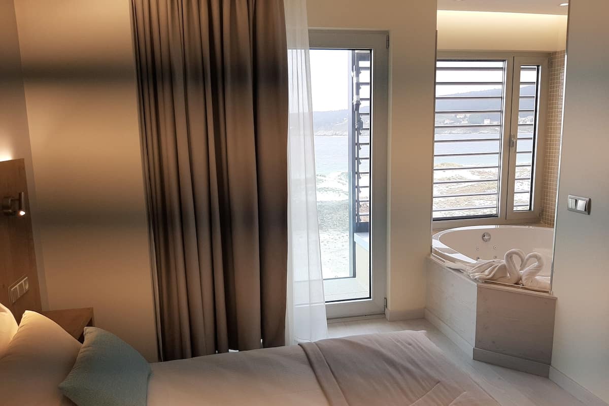 Luxury Double Room, Hot Tub, Sea View | Minibar, in-room safe, desk, laptop workspace