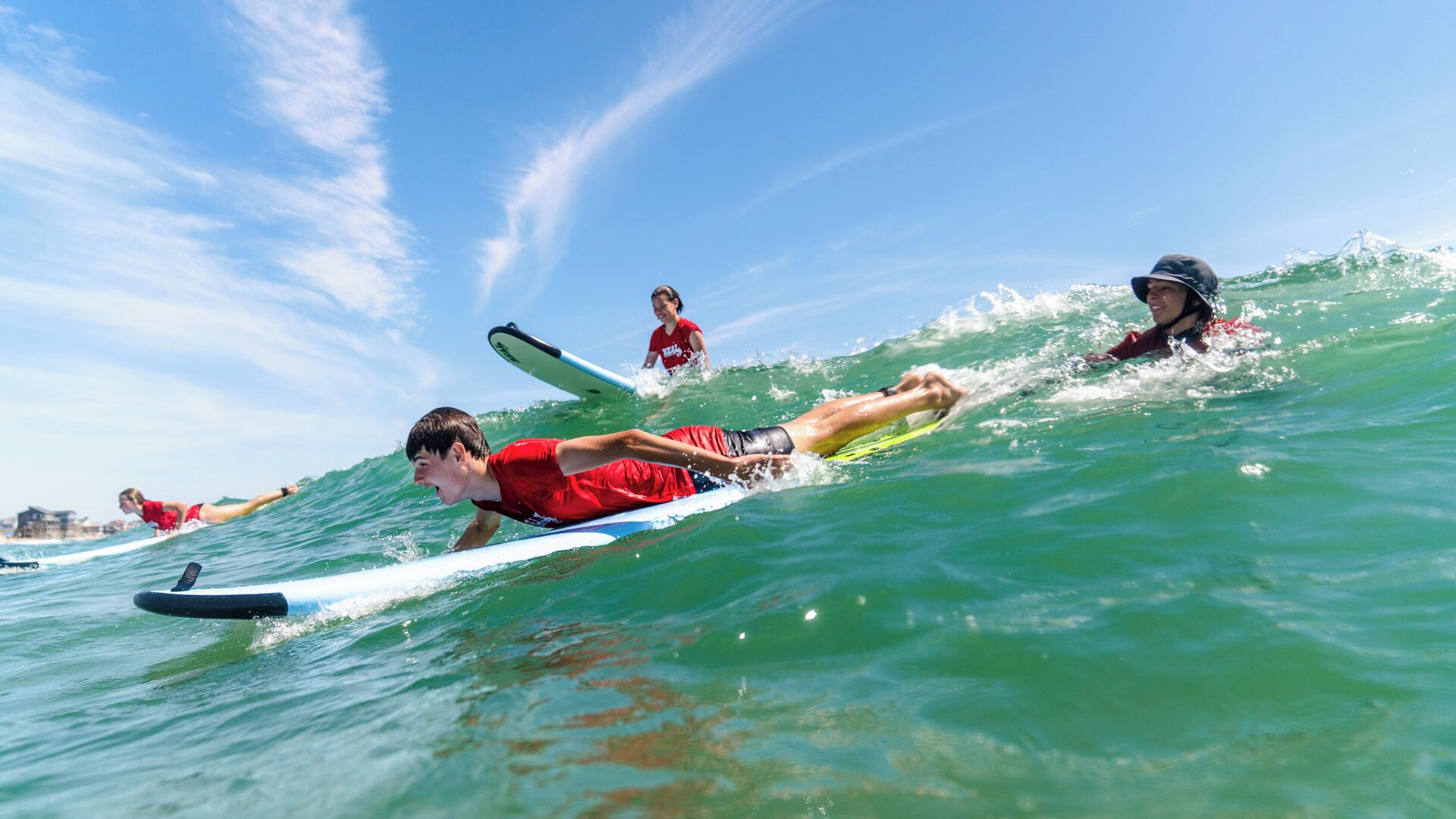 A group of people surfing on a wave.