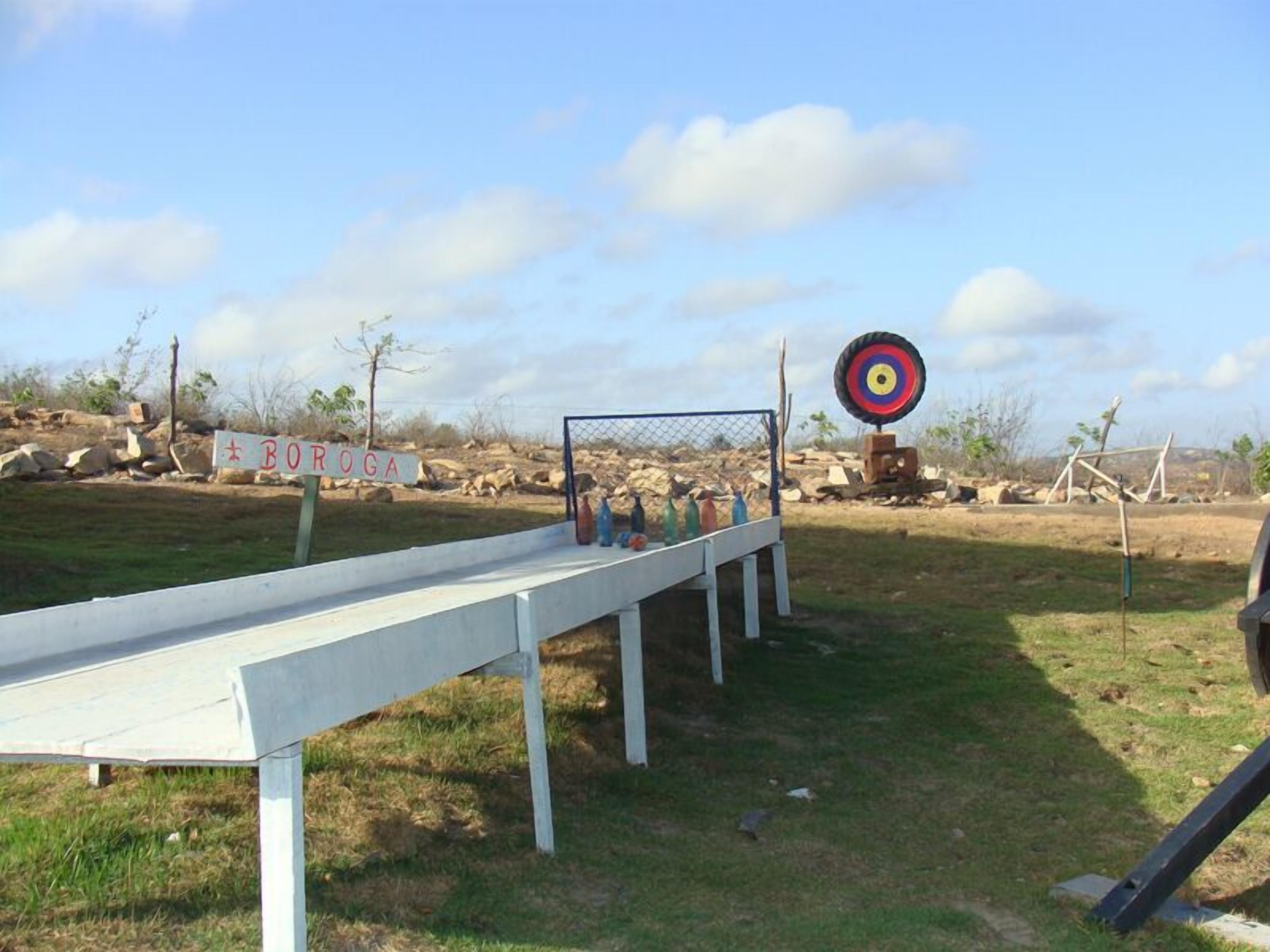 A target practice setup with a sign reading "BORA" and a target in the background.