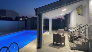 A modern outdoor pool area with a covered seating area, stairs, and a view of the mountains in the background. - 3: Peace and quiet, between the sea and the mountains, in the countryside (Golubovci)
