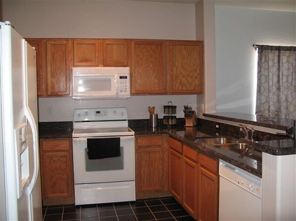 Enjoy cooking in this well-equipped kitchen with a microwave, stove, oven, and dishwasher.