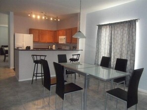 Enjoy meals in the kitchen and dining area, featuring a microwave, sink, and ample storage.