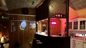 A bar area with stools, a dartboard, and a neon 'OPEN' sign. - Whole basement former pub 4 stag do (VIII. kerület)