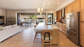 A modern kitchen with wooden cabinets, stainless steel appliances, and a central island.